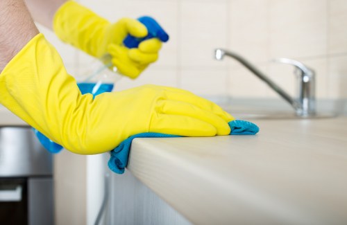 Cleaner working in a Wandsworth apartment with dusting and vacuuming tasks